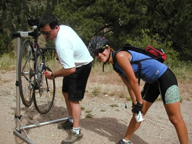 Then, halfway up our first mountain, he magically appeared with his portable bike stand to fix Leah's derailleur.