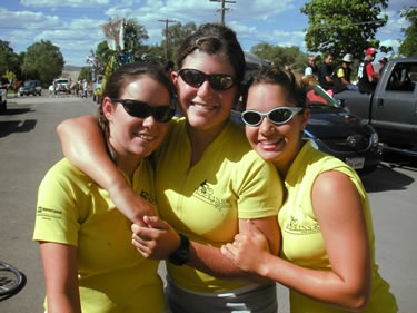 Steph and both Ashleys pose in front of parade floats.